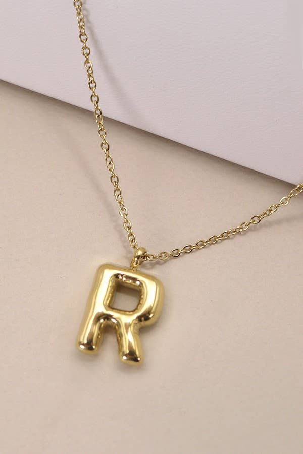 "Gold-tone necklace featuring a puffed, balloon-style pendant in the shape of the letter 'R' suspended from a delicate gold chain. Stylish and minimalistic, ideal for personalizing any outfit."