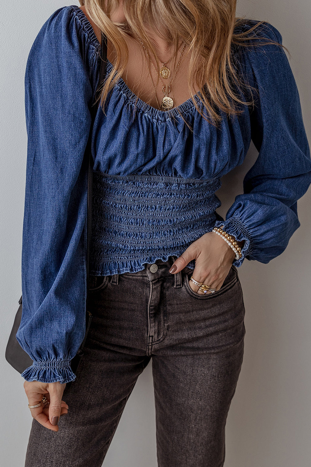 Smocked waist long sleeve denim blouse, spring 2025, trendy denim top, stylish smocked blouse, flattering waist-cinching design, casual yet chic denim shirt, lightweight and breathable denim, long sleeve blouse, modern denim fashion, effortless day-to-night top, trendy smocked waist detail, denim blouse, must-have spring outfit, comfortable and stylish fit, timeless denim staple, perfect for layering