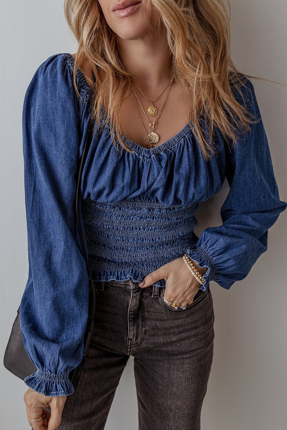 Smocked waist long sleeve denim blouse, spring 2025, trendy denim top, stylish smocked blouse, flattering waist-cinching design, casual yet chic denim shirt, lightweight and breathable denim, long sleeve blouse, modern denim fashion, effortless day-to-night top, trendy smocked waist detail, denim blouse, must-have spring outfit, comfortable and stylish fit, timeless denim staple, perfect for layering