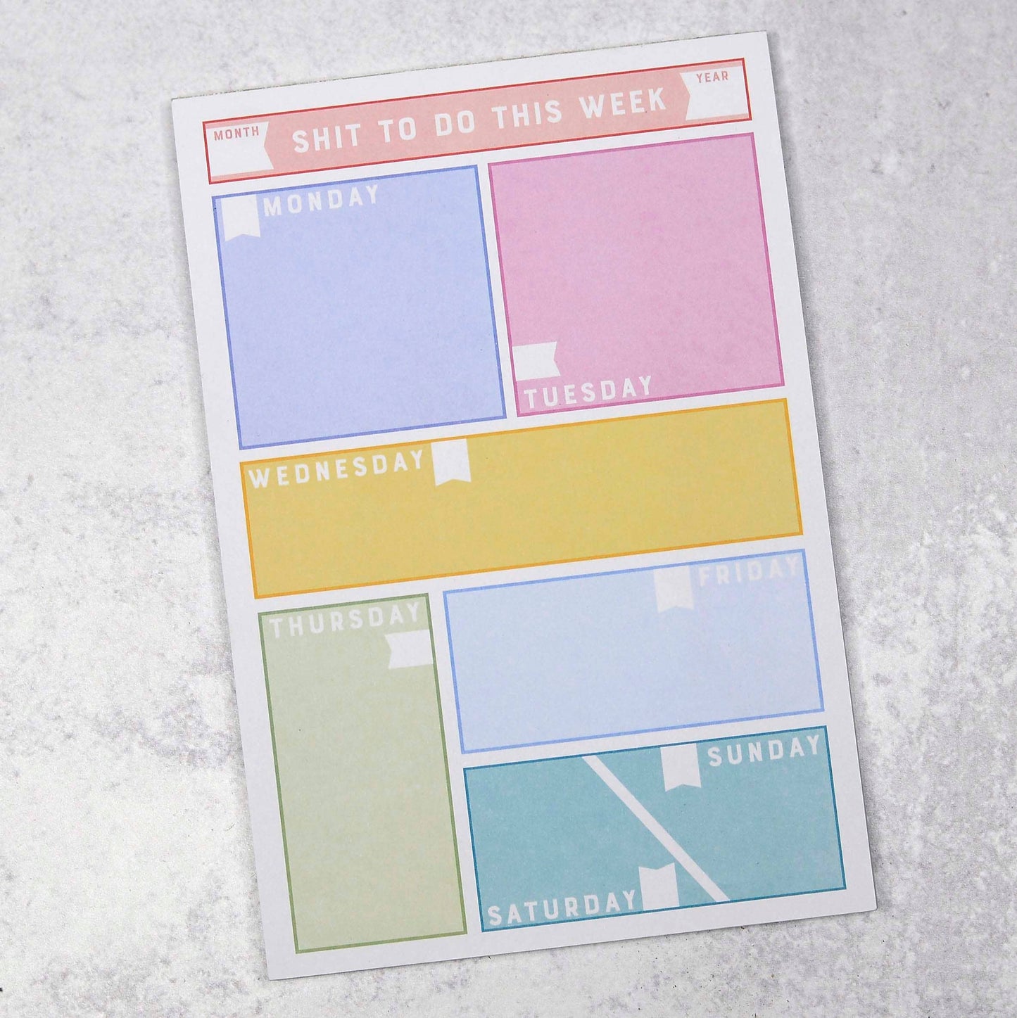 A colorful weekly planner with the title "Shit To Do This Week" at the top. Each day of the week is displayed in a pastel-colored box: Monday in blue, Tuesday in pink, Wednesday in yellow, Thursday in green, Friday in light blue, Saturday in teal, and Sunday in aqua, set against a white background.