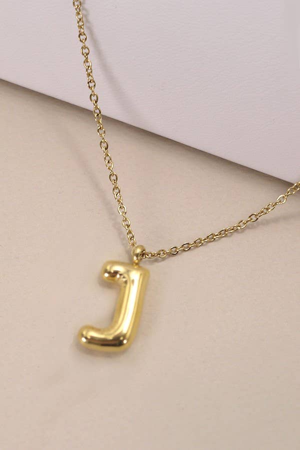 "Gold-tone necklace featuring a puffed, balloon-style pendant in the shape of the letter 'J,' suspended from a delicate gold chain. Stylish and minimalistic, ideal for personalizing any outfit."