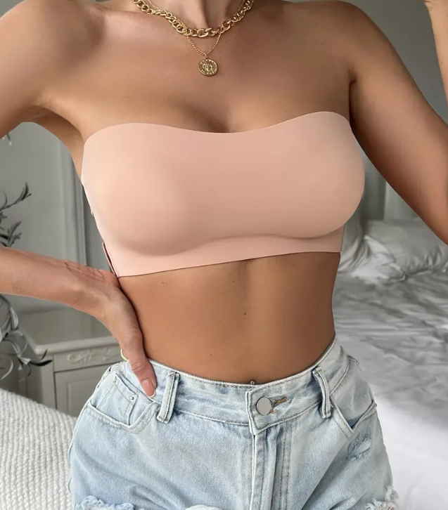 Nude strapless bandeau styled with light-wash denim shorts, providing a neutral and seamless fit under any outfit.