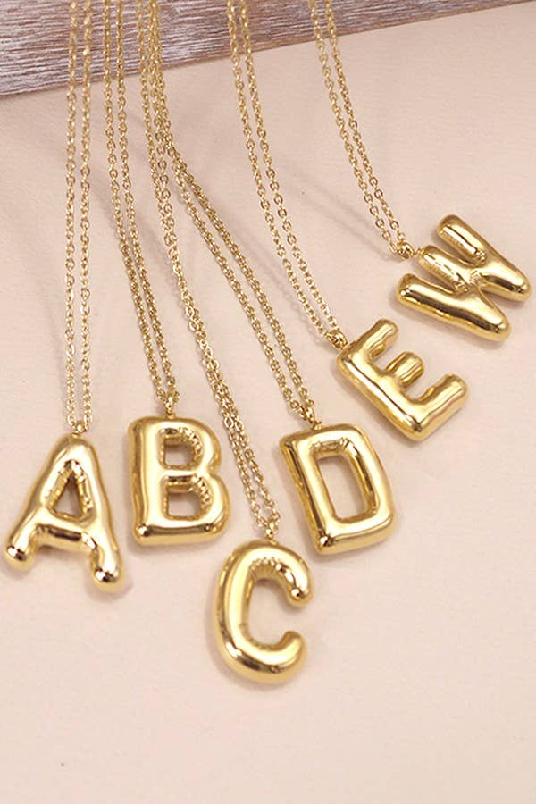 "Gold-tone necklace featuring a puffed, balloon-style pendant in the shape a letter suspended from a delicate gold chain. Stylish and minimalistic, ideal for personalizing any outfit."
