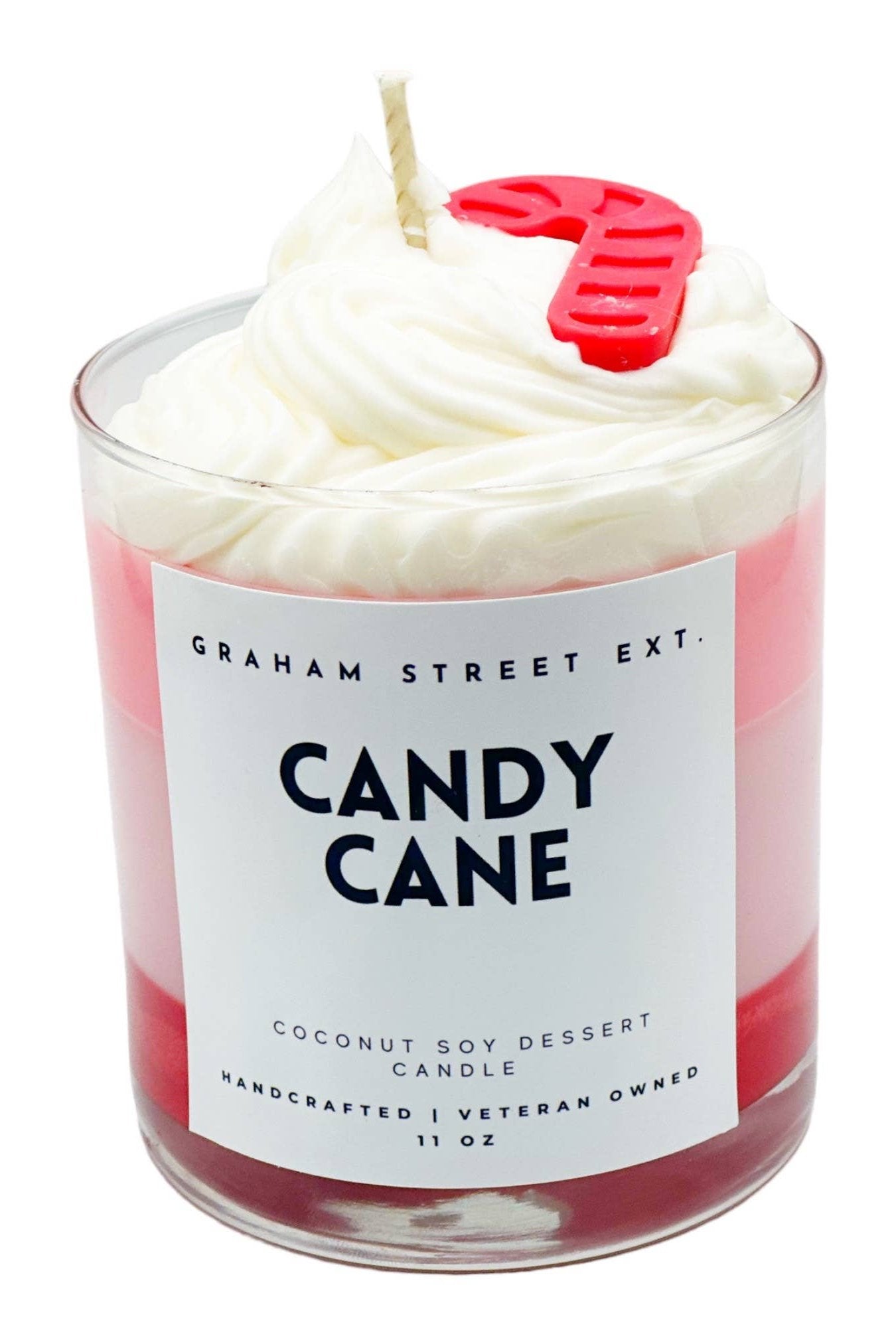 "Festive dessert-style candle labeled 'Candy Cane' by Graham Street Ext., featuring layers of red and white, topped with whipped cream-like detailing, a striped wick, and a decorative red candy cane accent."