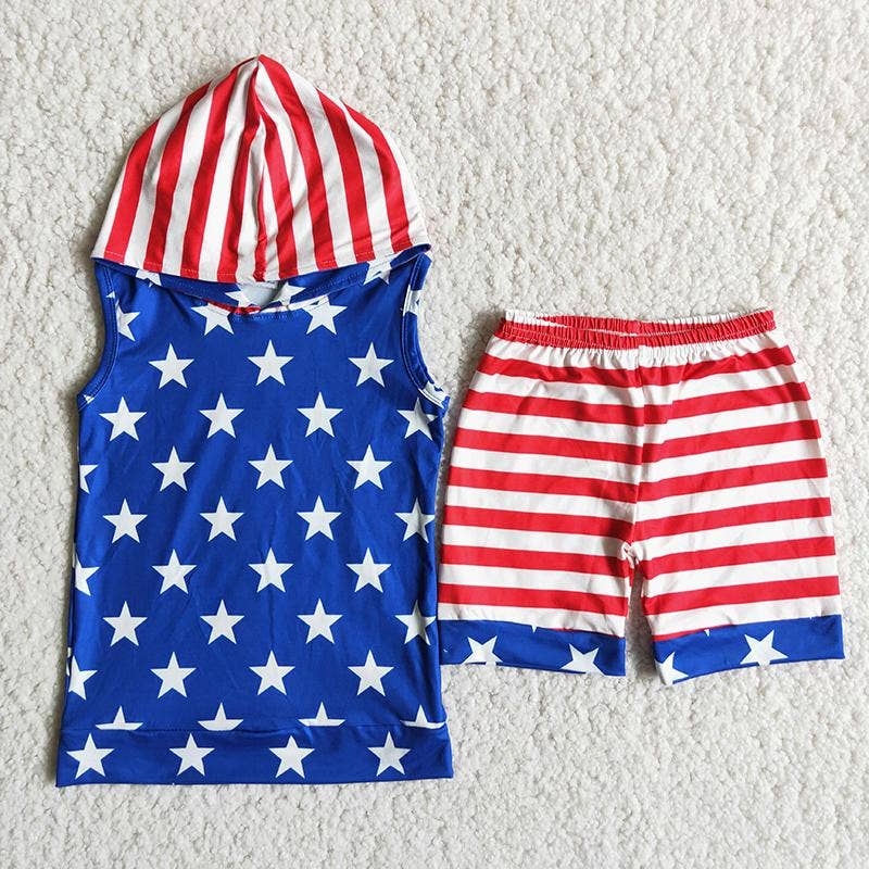A two-piece kids' outfit with a patriotic theme, featuring a blue sleeveless hooded top adorned with white stars and a hood with red and white stripes. The matching shorts have red and white horizontal stripes with blue cuffs featuring white stars. The outfit is displayed on a soft, textured white surface.
