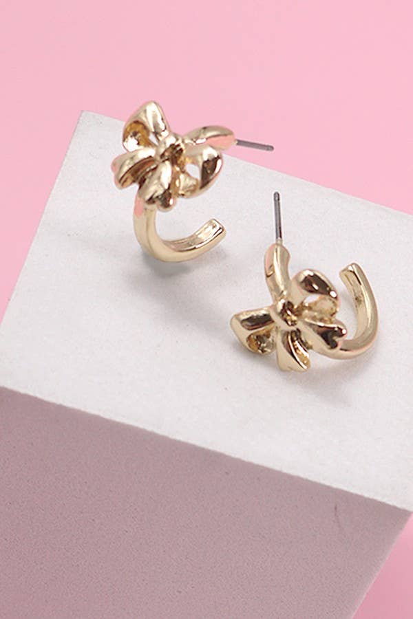 Elegant gold-tone stud earrings in a bow design, featuring a polished finish and curved details for a stylish and feminine look. Perfect for casual or formal wear, adding a chic touch to any outfit.