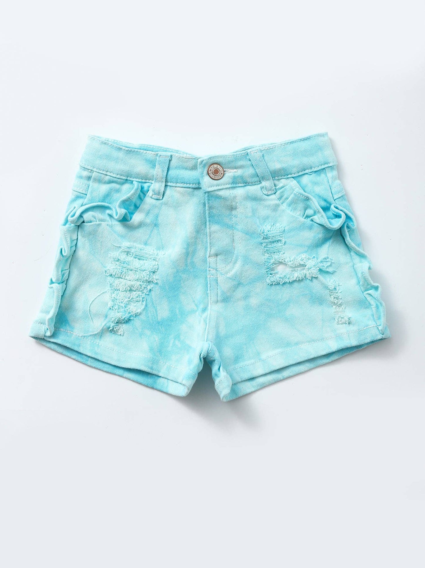 Adorable light blue tie-dye denim shorts for girls, featuring distressed detailing, subtle ruffle accents along the sides, and a button closure. Styled with a sleeveless white button-front top, these shorts create a playful, summery outfit perfect for casual outings or photoshoots. Modeled in front of a green floral backdrop with neon 'Bomb' signage.