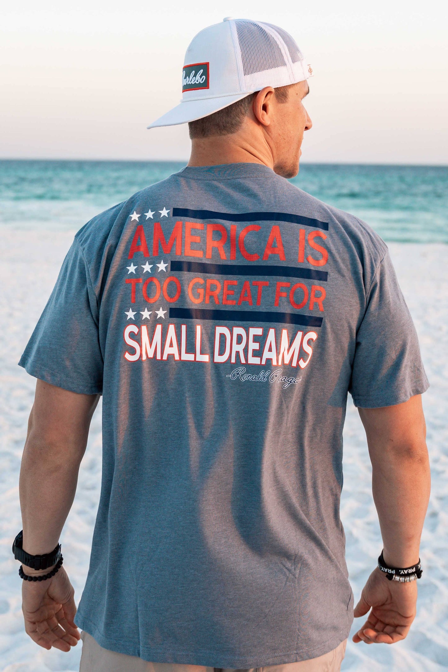 Burlebo grey and blue shirt with 'America is too great for small dreams' slogan, patriotic graphic tee, men's and women's American pride shirt, soft and comfortable Burlebo brand apparel, USA-inspired casual shirt