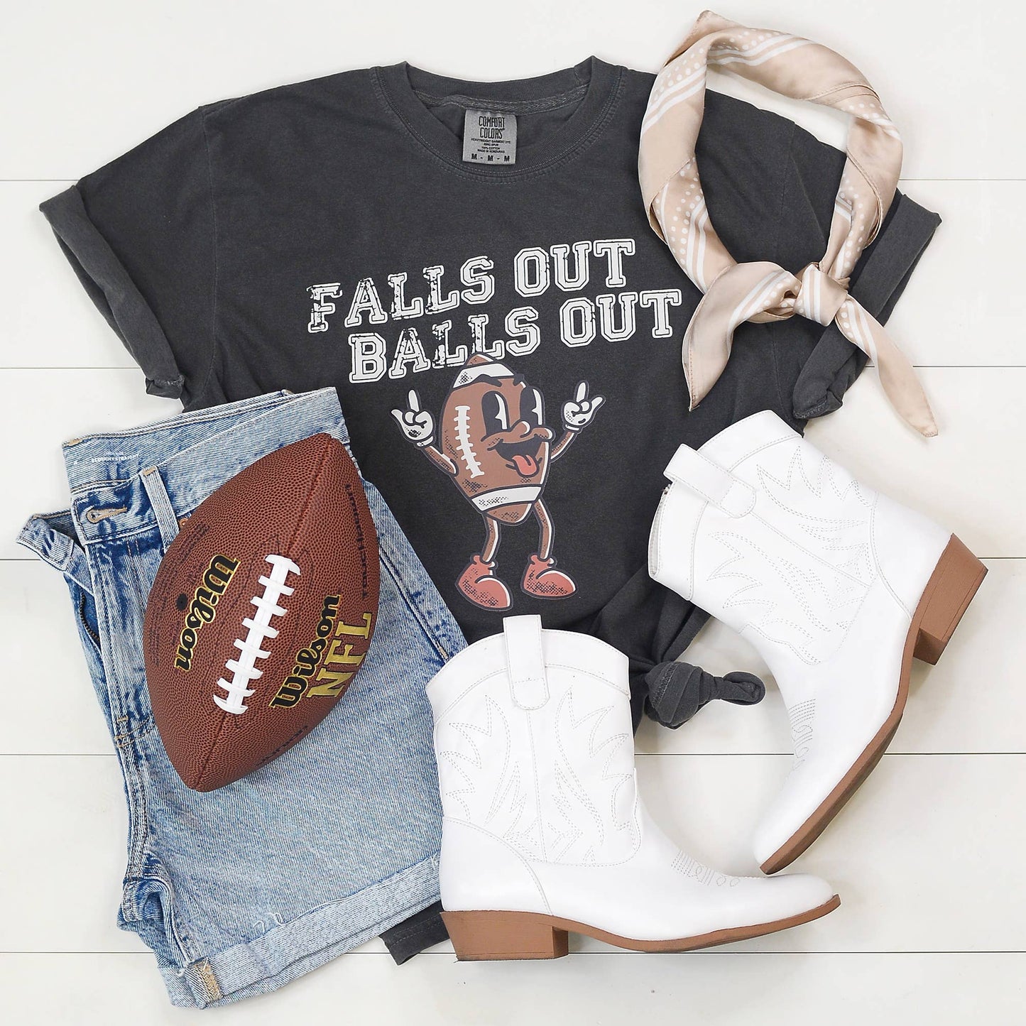 Graphic tee with 'Falls Out Balls Out' slogan and football graphic, funny fall football shirt, sports-themed t-shirt for game day, humorous football season apparel, unisex casual tee for fall