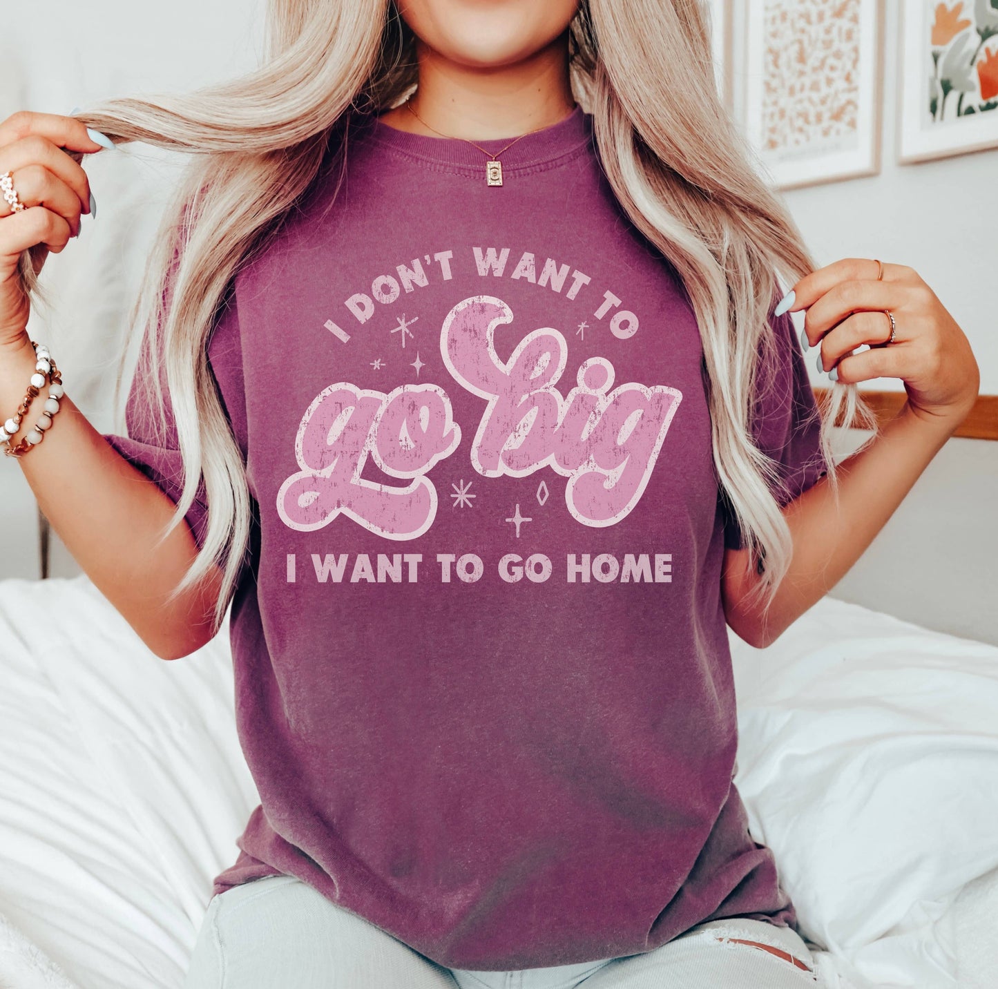 Image of a graphic tee featuring the bold text, "I Don't Want to Go Big, I Want to Go Home," in a playful, eye-catching font. The design captures a relaxed, casual vibe, perfect for those who prefer comfort over grandeur. The tee is made from soft, breathable fabric, offering a relaxed fit that pairs well with jeans, shorts, or skirts. This graphic shirt makes a fun statement and is ideal for anyone who enjoys expressing their laid-back attitude through fashion.