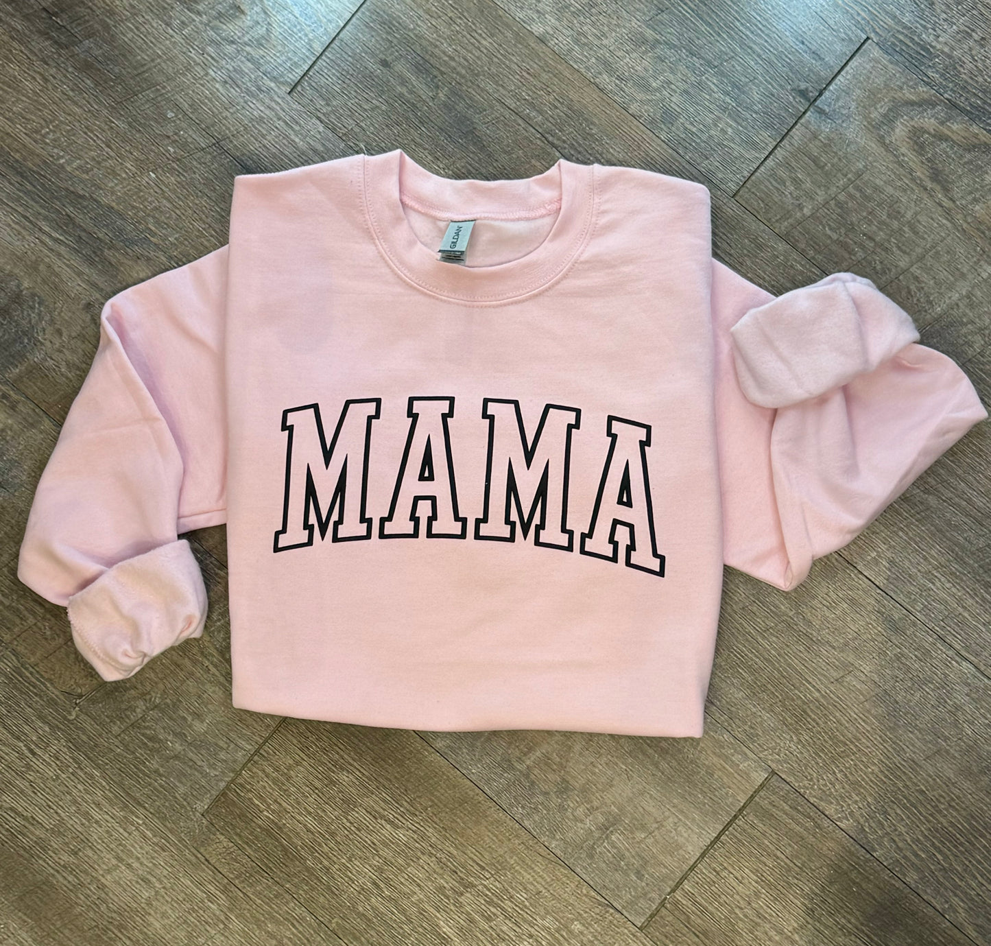 Stylish Mama crewneck sweatshirt for women, featuring a comfortable and relaxed fit with a bold 'Mama' graphic design. Perfect for casual wear or lounging, this soft sweatshirt offers warmth and cozy comfort. Made from high-quality fabric, it pairs effortlessly with jeans, leggings, or shorts for an easy, chic look. Available in various sizes and colors, this crewneck sweatshirt is a must-have for moms looking for both comfort and style in their everyday wardrobe