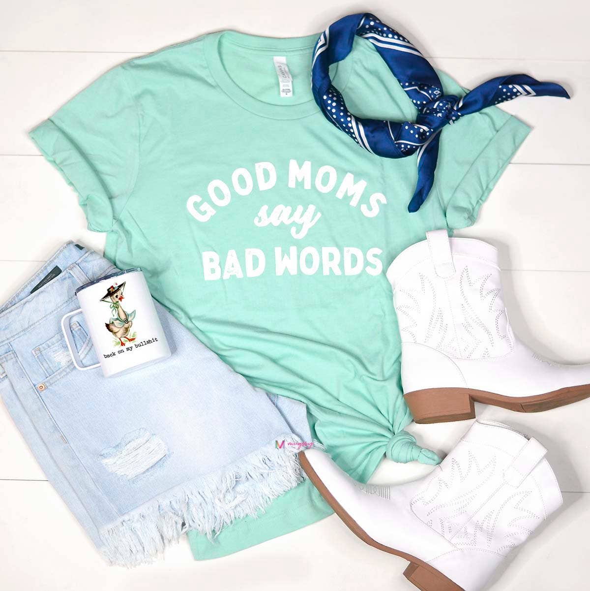 Funny 'Good Moms Say Bad Words' graphic tee for women, featuring a bold and humorous statement design. Made from soft, breathable fabric, this comfortable t-shirt offers a relaxed fit and is perfect for casual outings, lounging, or gifting to a fellow mom. Available in various sizes and colors, this graphic tee adds a touch of personality and humor to any wardrobe. A must-have for moms who embrace their real, unapologetic selves