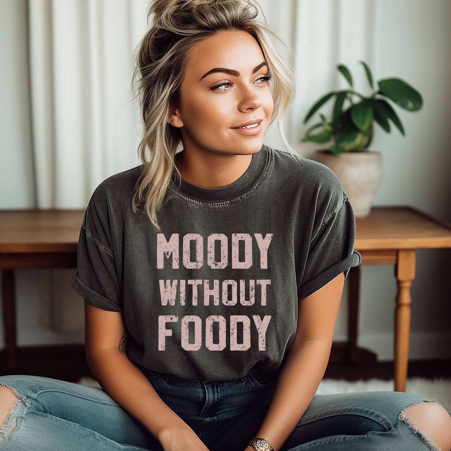 Trendy 'Moody without Foody' graphic tee for women, featuring a playful and humorous design that showcases a love for food. Made from soft, comfortable fabric, this relaxed fit t-shirt is perfect for casual wear, weekend outings, or as a fun gift for food lovers. Available in various sizes and colors, this graphic tee adds personality and style to any wardrobe, making it a must-have for those who appreciate a witty and relatable statement