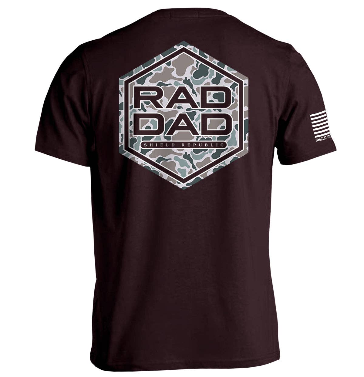 A black short-sleeve t-shirt featuring a large hexagonal graphic on the back with the words "RAD DAD" in bold, uppercase letters, set against a gray-green camouflage pattern. Below the text, the phrase "Shield Republic" is displayed in a small, clean font. The right sleeve includes a white American flag design with "Shield Republic" text underneath, adding a patriotic touch. The shirt offers a casual and rugged aesthetic, ideal for dads with a bold, adventurous style.