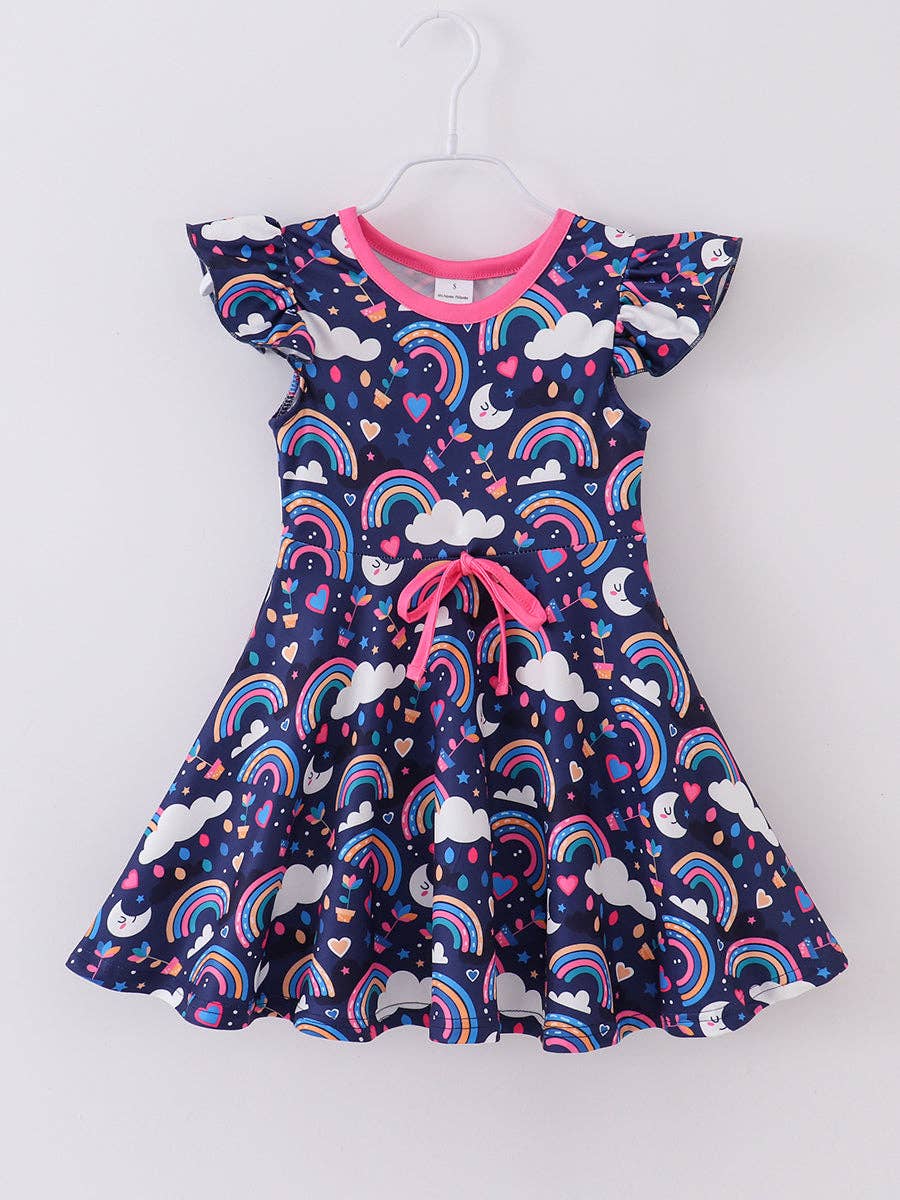 A colorful, sleeveless girls' dress featuring a playful, navy blue background adorned with vibrant prints of rainbows, clouds, stars, hearts, potted plants, and crescent moons with smiling faces. The dress has flutter sleeves, a bright pink collar, and a matching pink drawstring detail at the waist for a cinched fit. The whimsical pattern and cheerful colors make it ideal for casual wear or fun occasions.