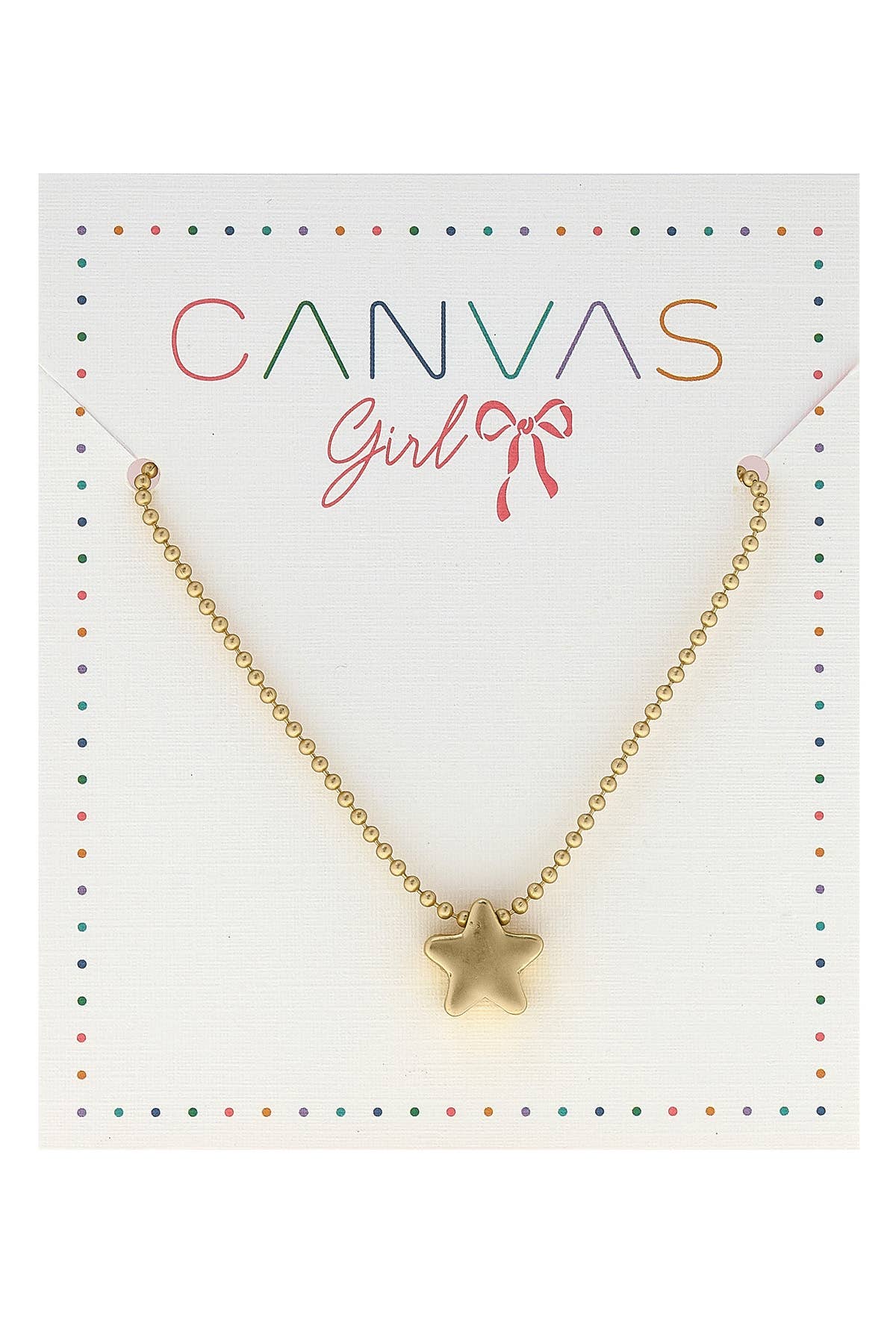 A gold necklace with small round beads and a star-shaped pendant, displayed on a white card with the branding "CANVAS Girl" written in colorful letters, accompanied by a small red ribbon illustration. The card is bordered with multicolored dots for a playful design.