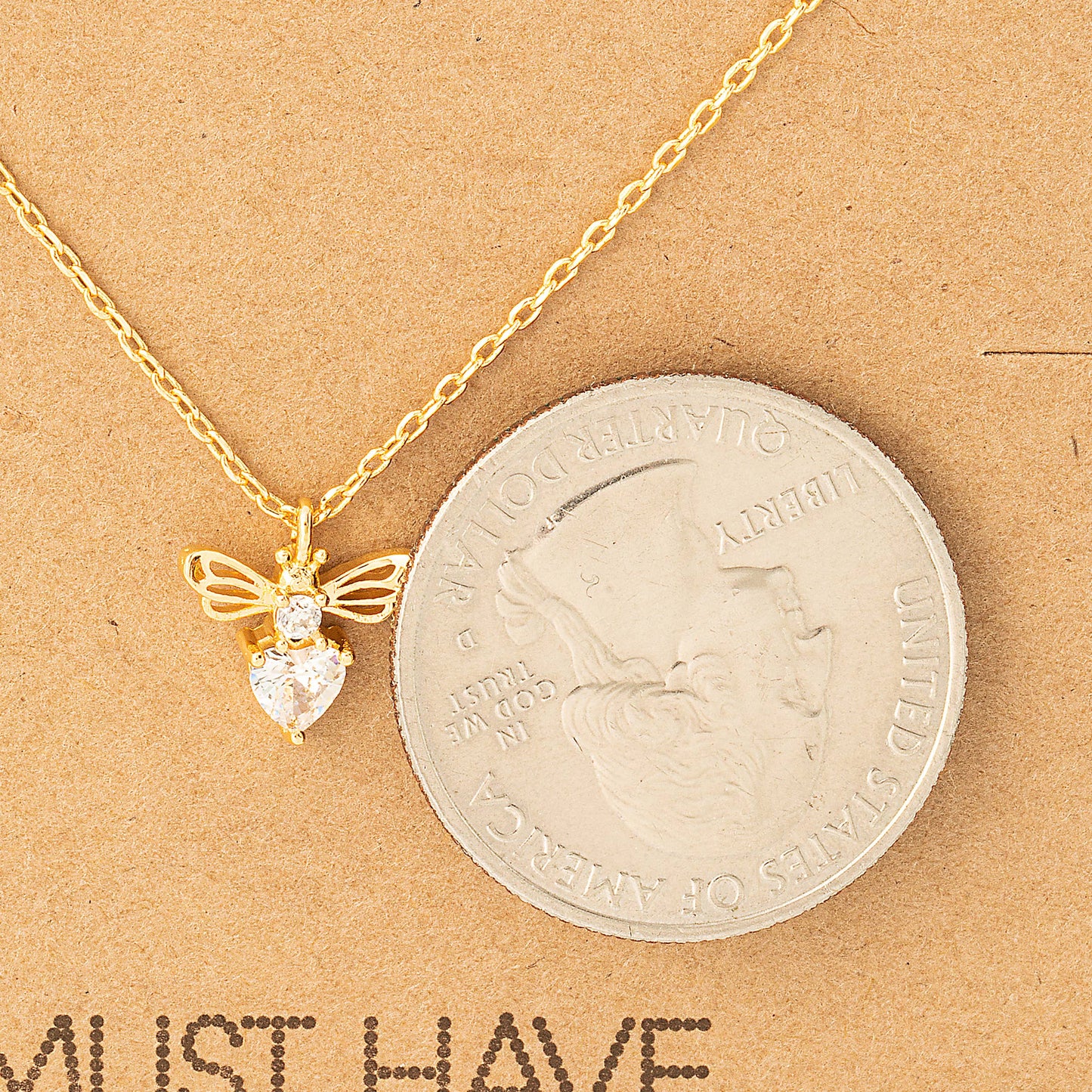 The same gold necklace is shown mounted on a minimalist kraft paper backing card. The card includes the text "MUST HAVE" and describes the product as "18K Gold Dipped" with a focus on "Vintage, Chic, Classic & Unique" design. The card is marked "Handmade in Korea," emphasizing its craftsmanship. Perfect for gift giving or personal wear.