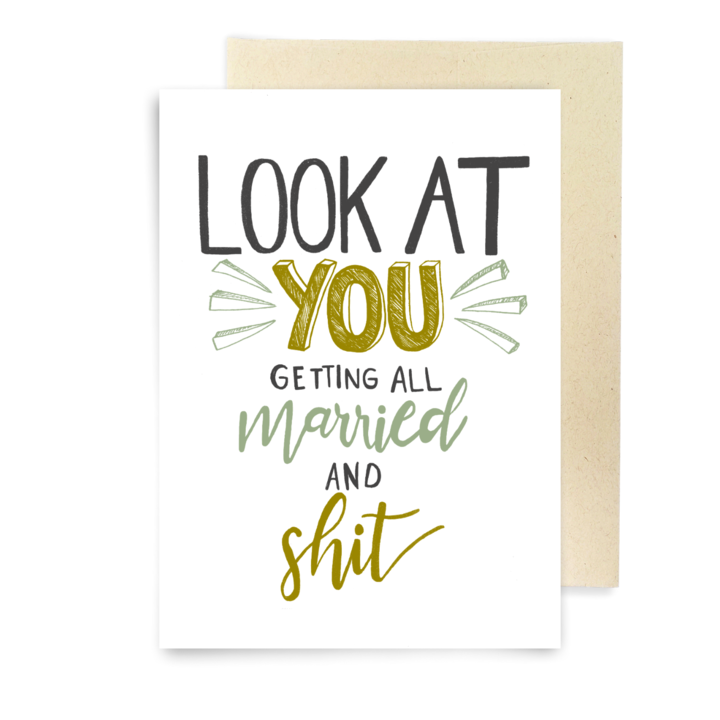 A humorous greeting card with bold, playful typography. The text reads, "LOOK AT YOU GETTING ALL married AND shit," with "YOU" and "shit" emphasized in gold lettering, "married" in green cursive, and other words in black. Decorative lines surround "YOU" for added emphasis. The card is displayed on a white background with a beige envelope partially visible behind it. Perfect for lighthearted wedding congratulations.