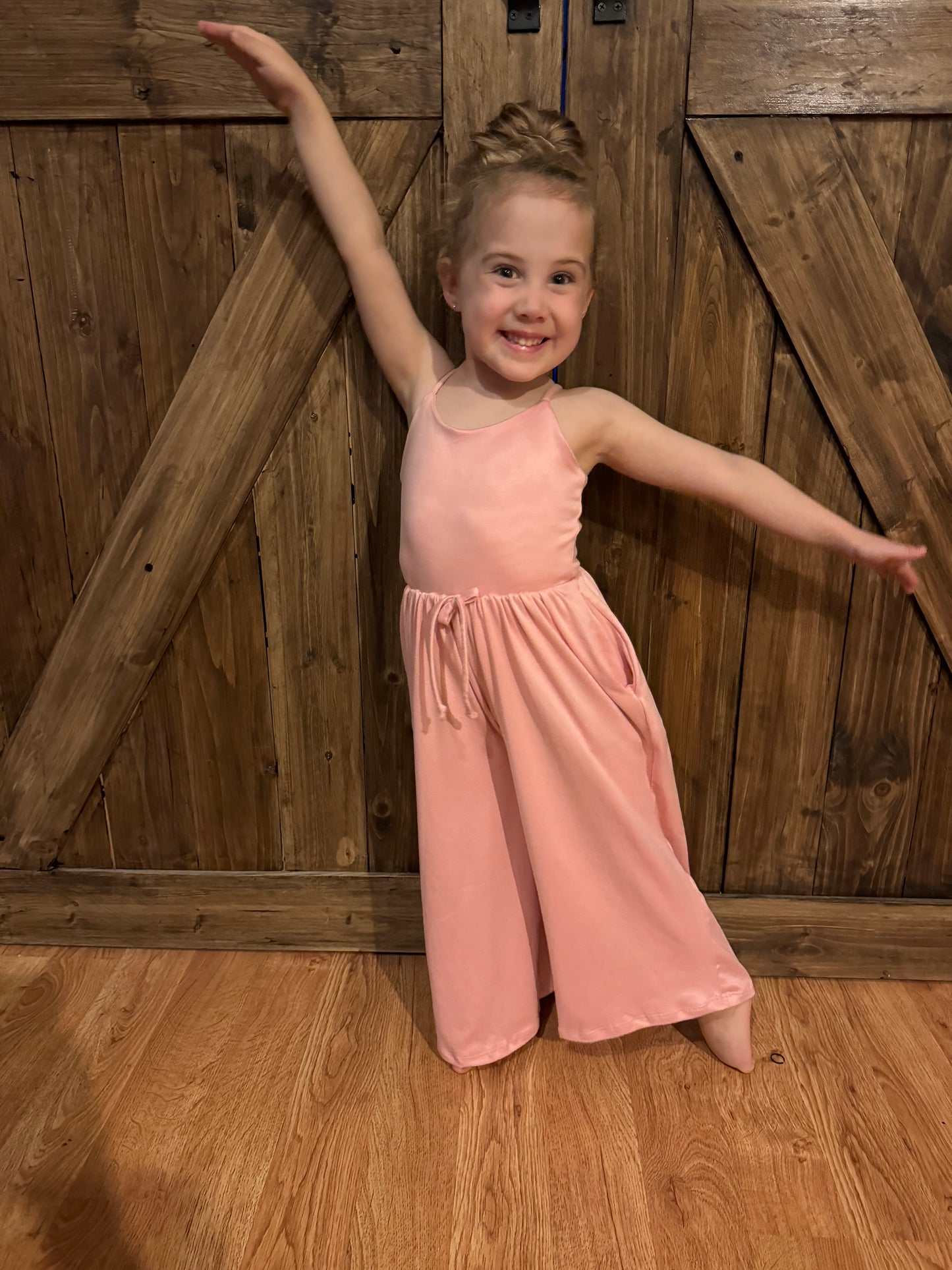 Adorable mommy and me pink jumpsuit set for women and kids, featuring a matching design for mom and child. This stylish jumpsuit offers a comfortable and flattering fit for both adults and children, making it perfect for family photos, outings, or casual wear. Made from soft, breathable fabric, it provides all-day comfort and easy wear. Available in various sizes for both moms and kids, this matching jumpsuit set is a must-have for families who love coordinated outfits