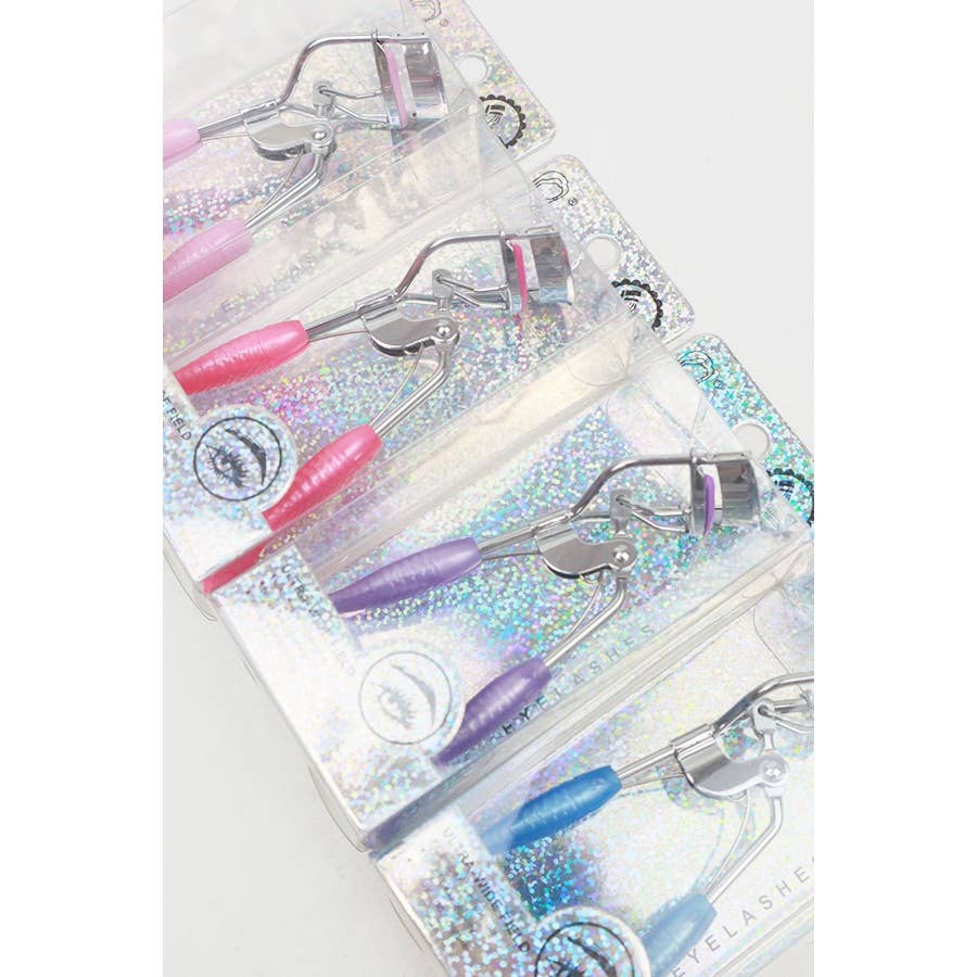 A set of four eyelash curlers displayed in glittery, holographic packaging. Each curler features a chrome metal frame with colorful silicone handles and matching curling pads in pastel shades of pink, purple, magenta, and blue. The packaging highlights their "Ultra-Wide Field" design, emphasizing functionality and style. Perfect for beauty enthusiasts seeking a pop of color in their makeup tools.