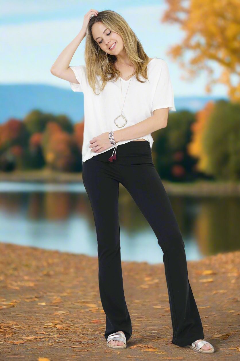 Image of classic fold-over yoga pants designed for comfort and flexibility. These pants feature a wide, fold-over waistband that can be adjusted for a customizable fit, providing gentle support without digging in. The soft, stretchy fabric hugs the hips and thighs before tapering down with a relaxed, straight or slightly flared leg, ideal for movement and relaxation. Perfect for yoga, lounging, or casual outings, these pants combine style and practicality, making them a go-to for effortless comfort.