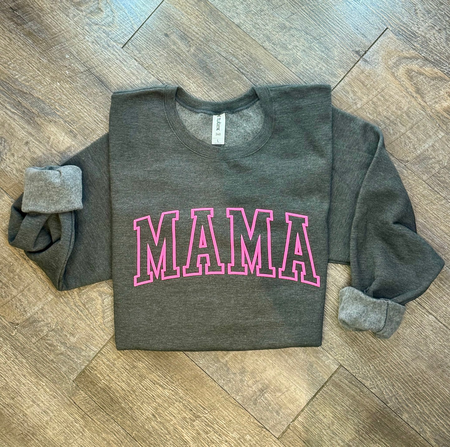 Stylish Mama crewneck sweatshirt for women, featuring a comfortable and relaxed fit with a bold 'Mama' graphic design. Perfect for casual wear or lounging, this soft sweatshirt offers warmth and cozy comfort. Made from high-quality fabric, it pairs effortlessly with jeans, leggings, or shorts for an easy, chic look. Available in various sizes and colors, this crewneck sweatshirt is a must-have for moms looking for both comfort and style in their everyday wardrobe