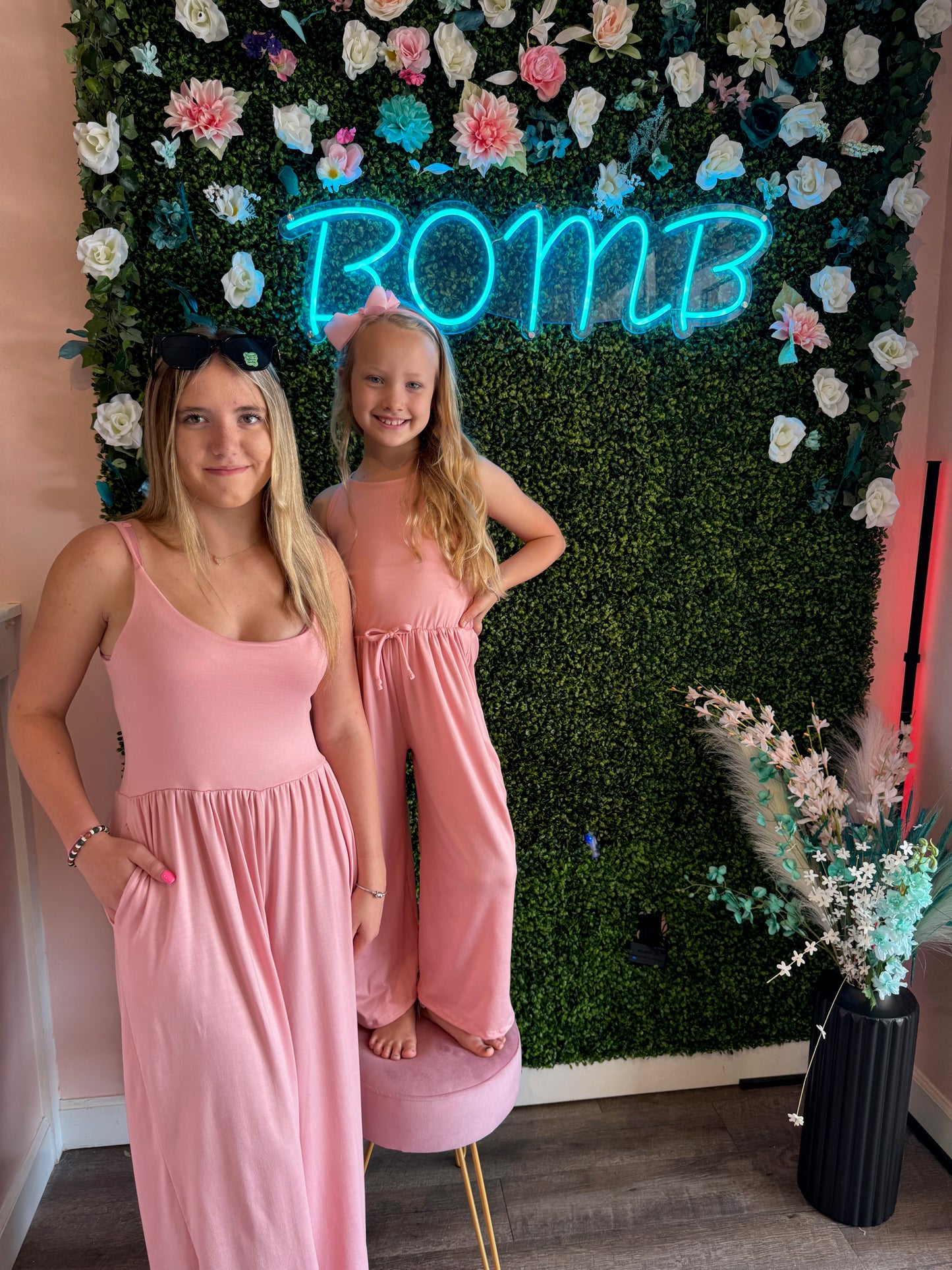 Adorable mommy and me pink jumpsuit set for women and kids, featuring a matching design for mom and child. This stylish jumpsuit offers a comfortable and flattering fit for both adults and children, making it perfect for family photos, outings, or casual wear. Made from soft, breathable fabric, it provides all-day comfort and easy wear. Available in various sizes for both moms and kids, this matching jumpsuit set is a must-have for families who love coordinated outfits