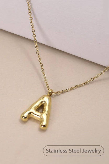 "Gold-tone necklace featuring a puffed, balloon-style pendant in the shape of the letter 'A,' suspended from a delicate gold chain. Stylish and minimalistic, ideal for personalizing any outfit."